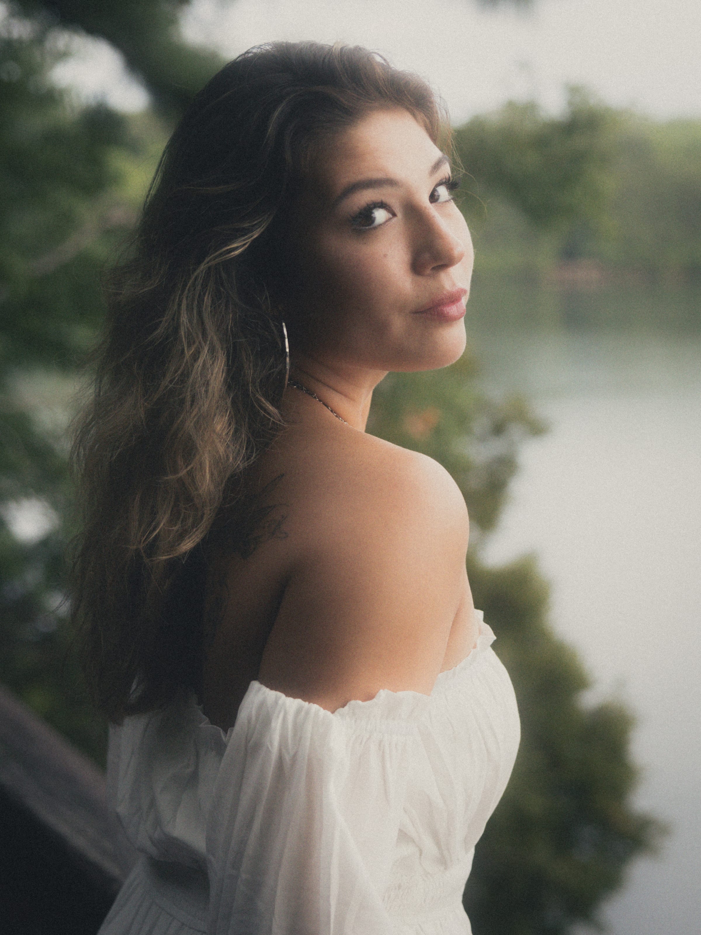 Over-shoulder gaze beside a fog-veiled lake