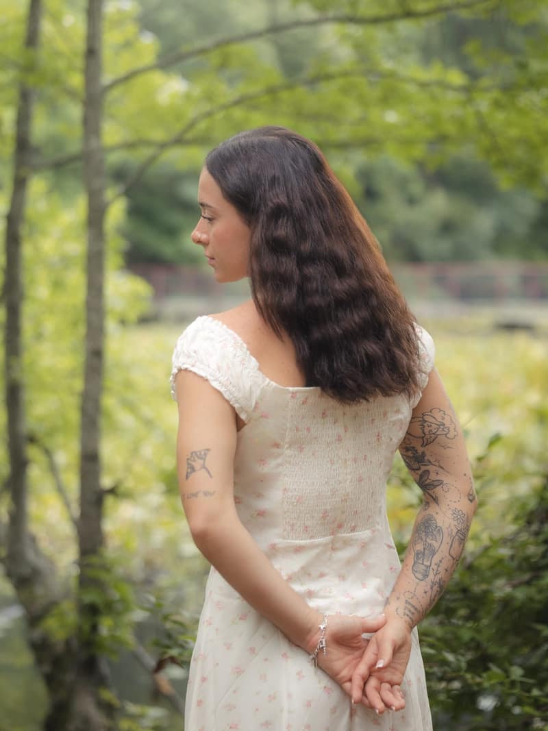 Contemplative figure in a forest clearing