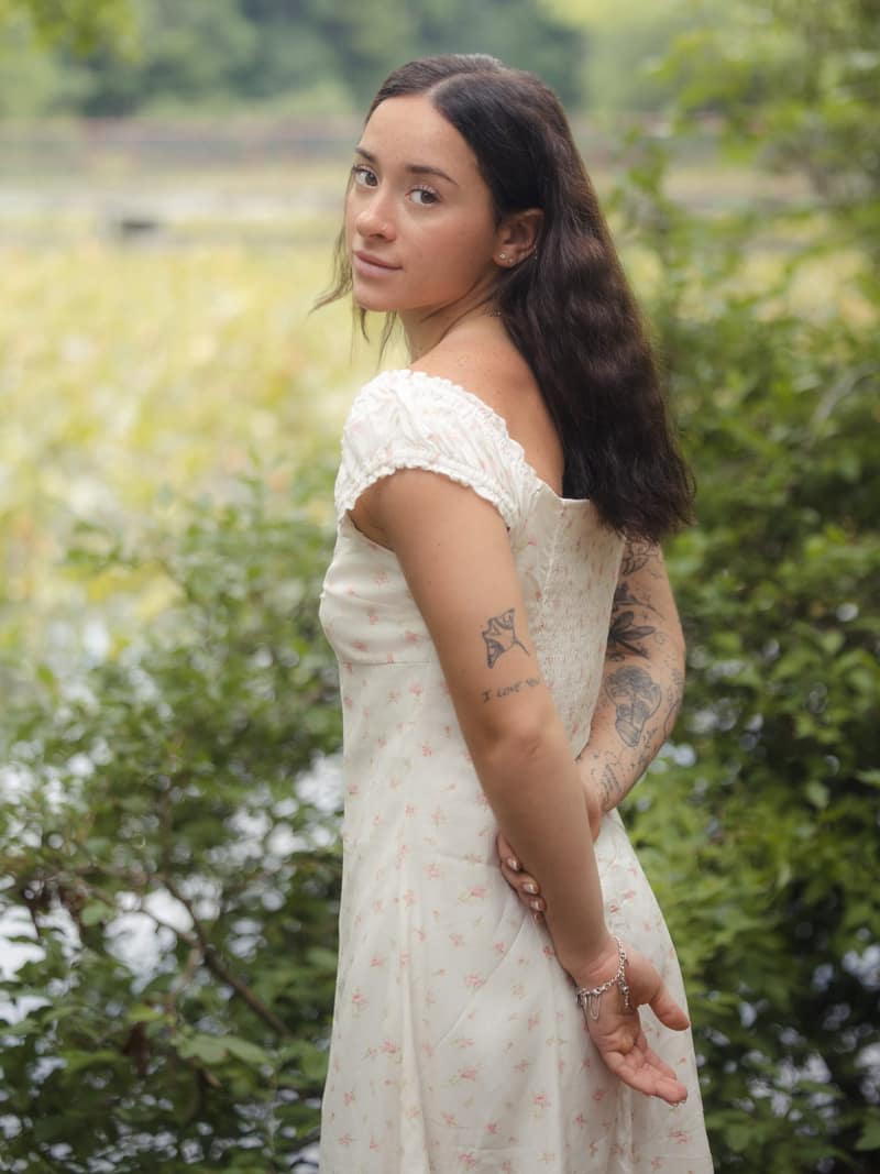 Over-shoulder gaze by lakeside greenery