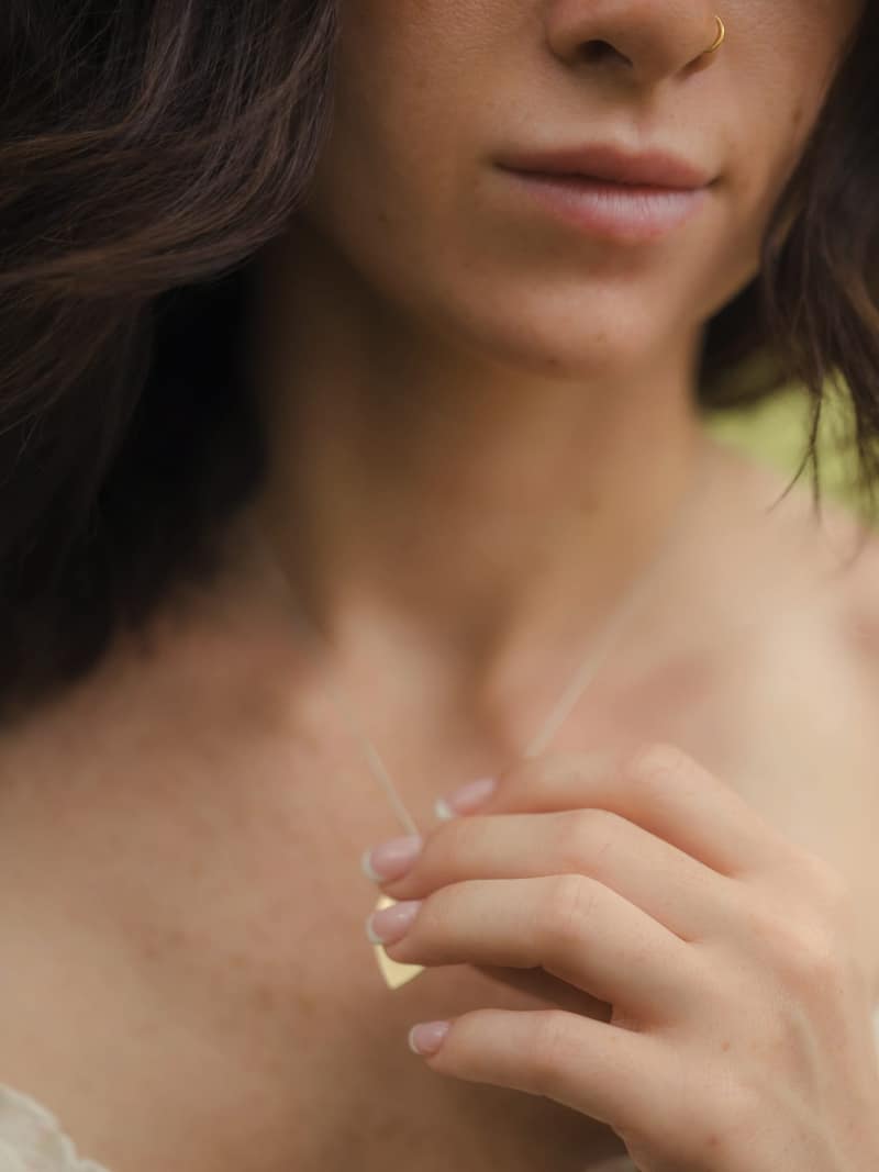 Dreamy close-up with hand clasping a pendant