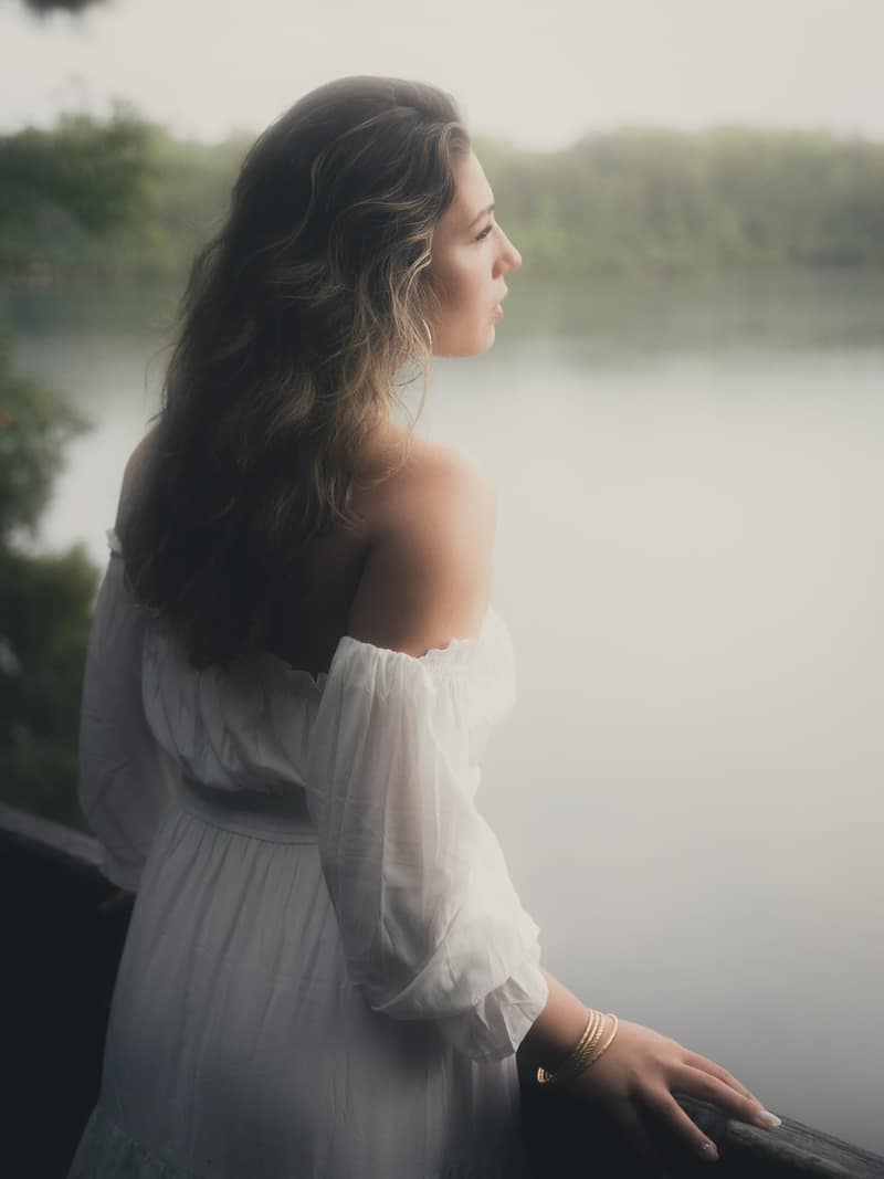 Profile at a railing above misted water