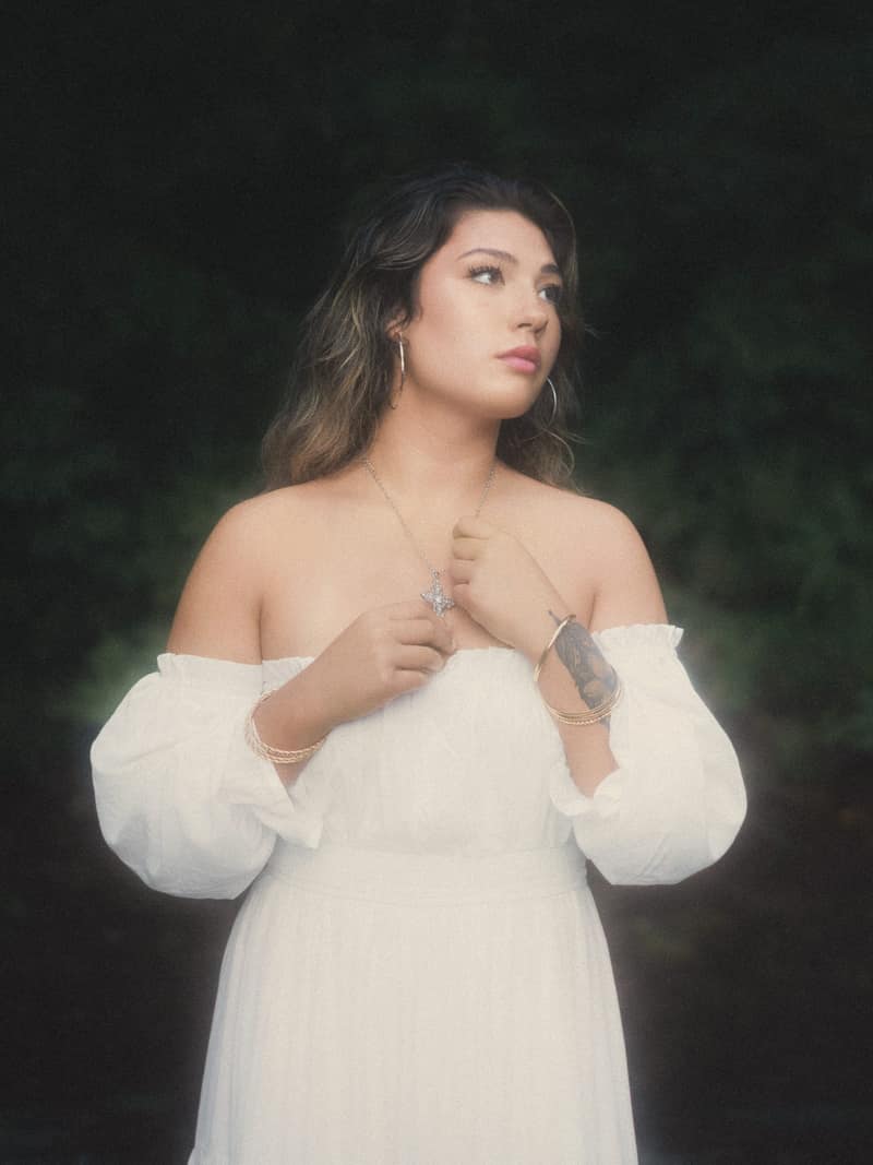 Portrait against dark leaves with rim light