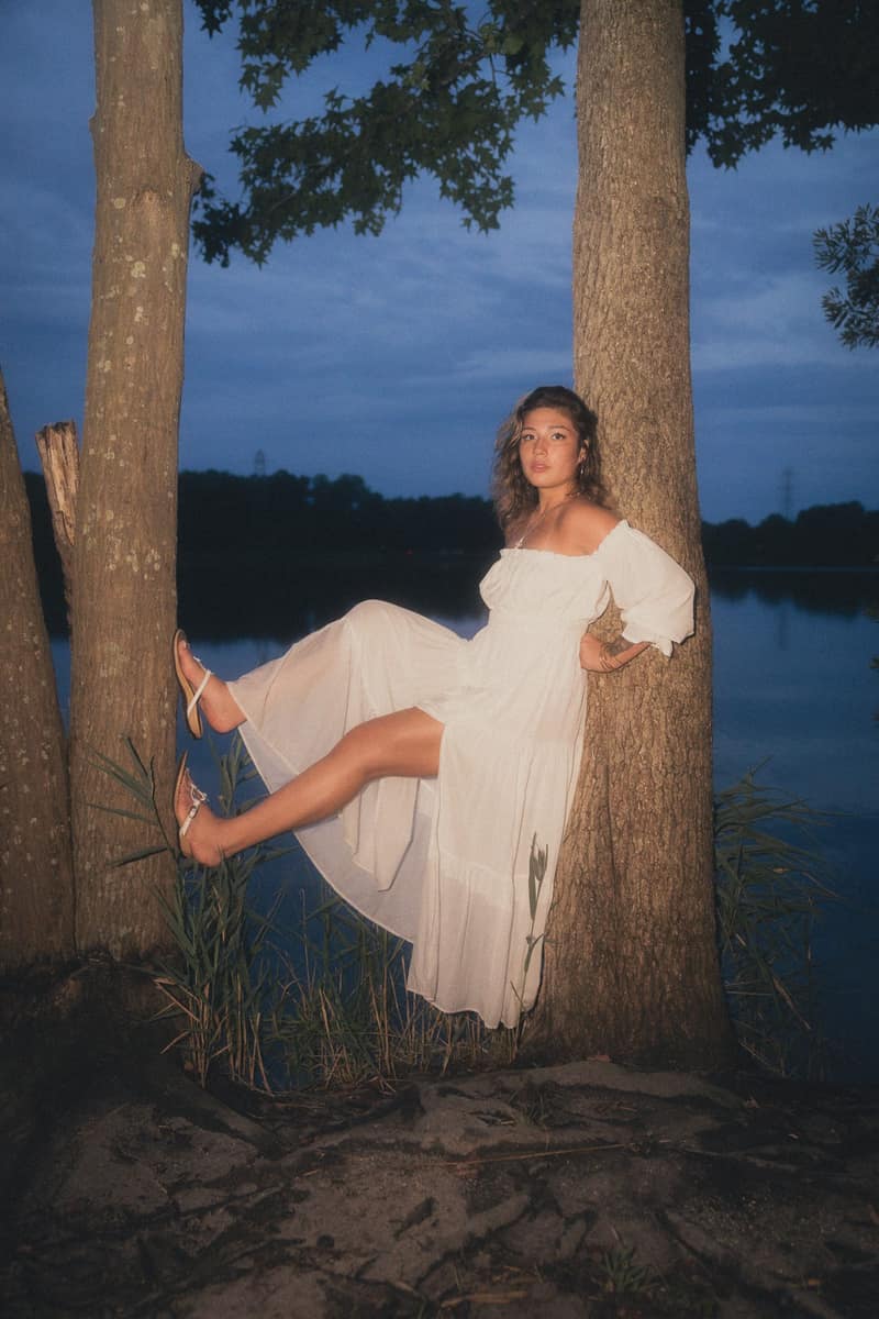 Reclining between lakeside trunks at blue hour
