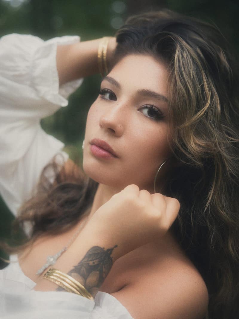 Beauty portrait with gold bangles and tattoos