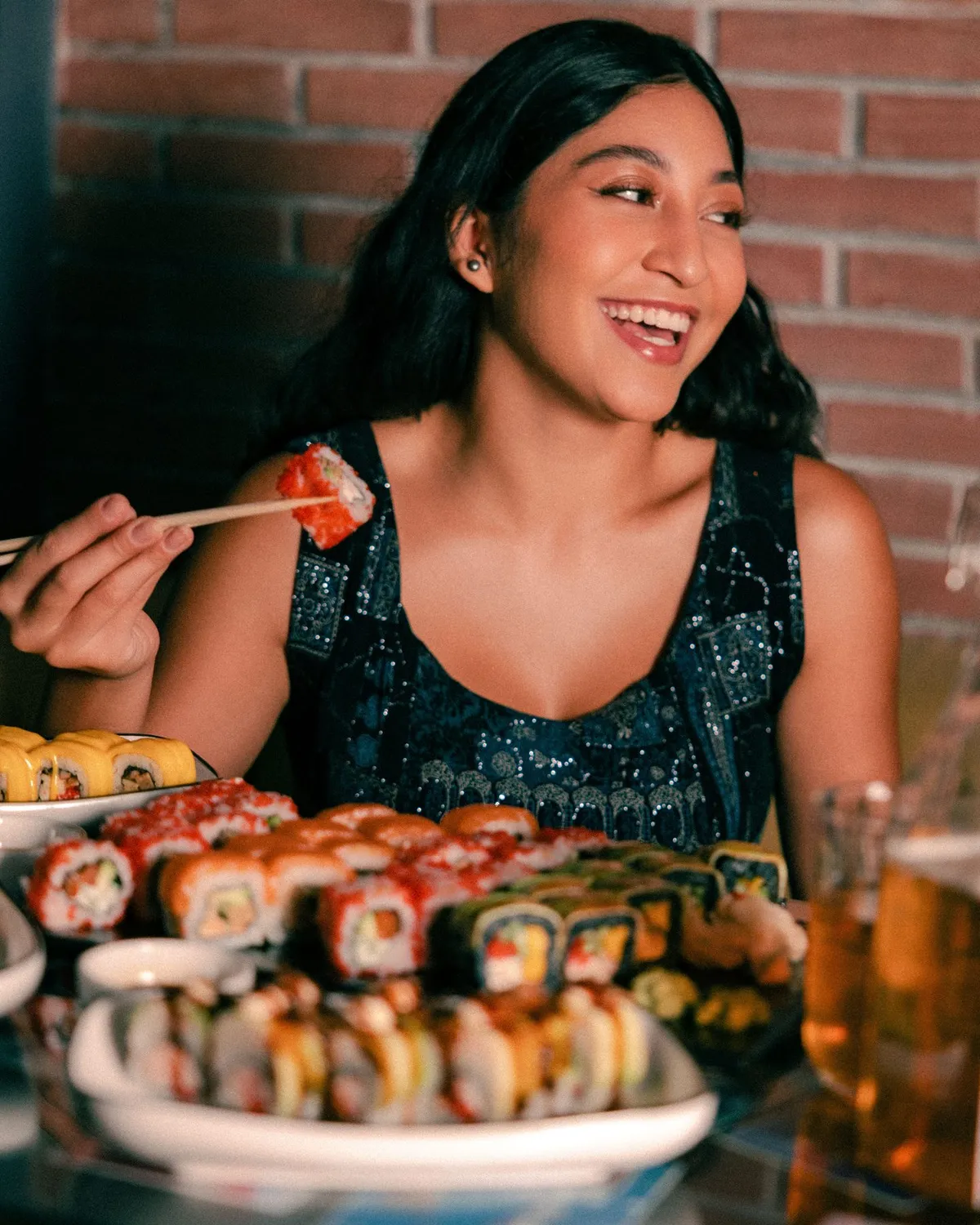 Smiling guest with sushi and chopsticks at the restaurant · Friends Sushi