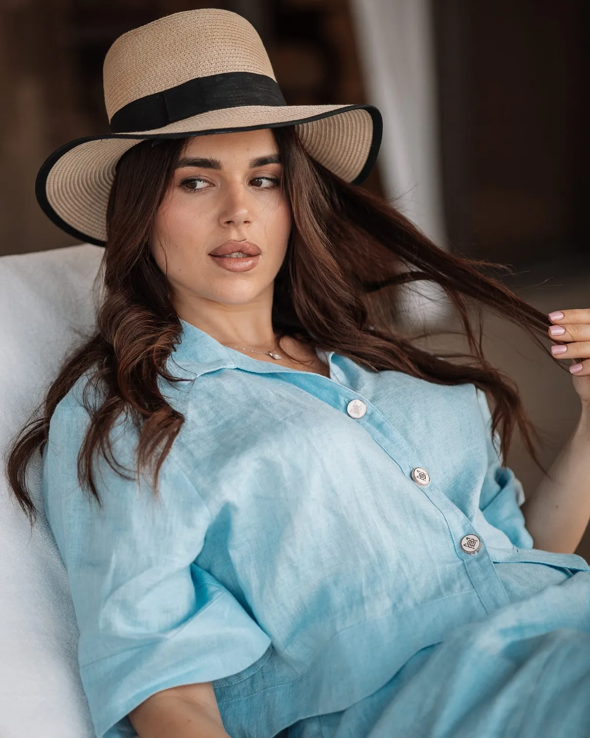 Hospitality lifestyle portrait in a blue shirt and sun hat · Royal Saray and Palavra
