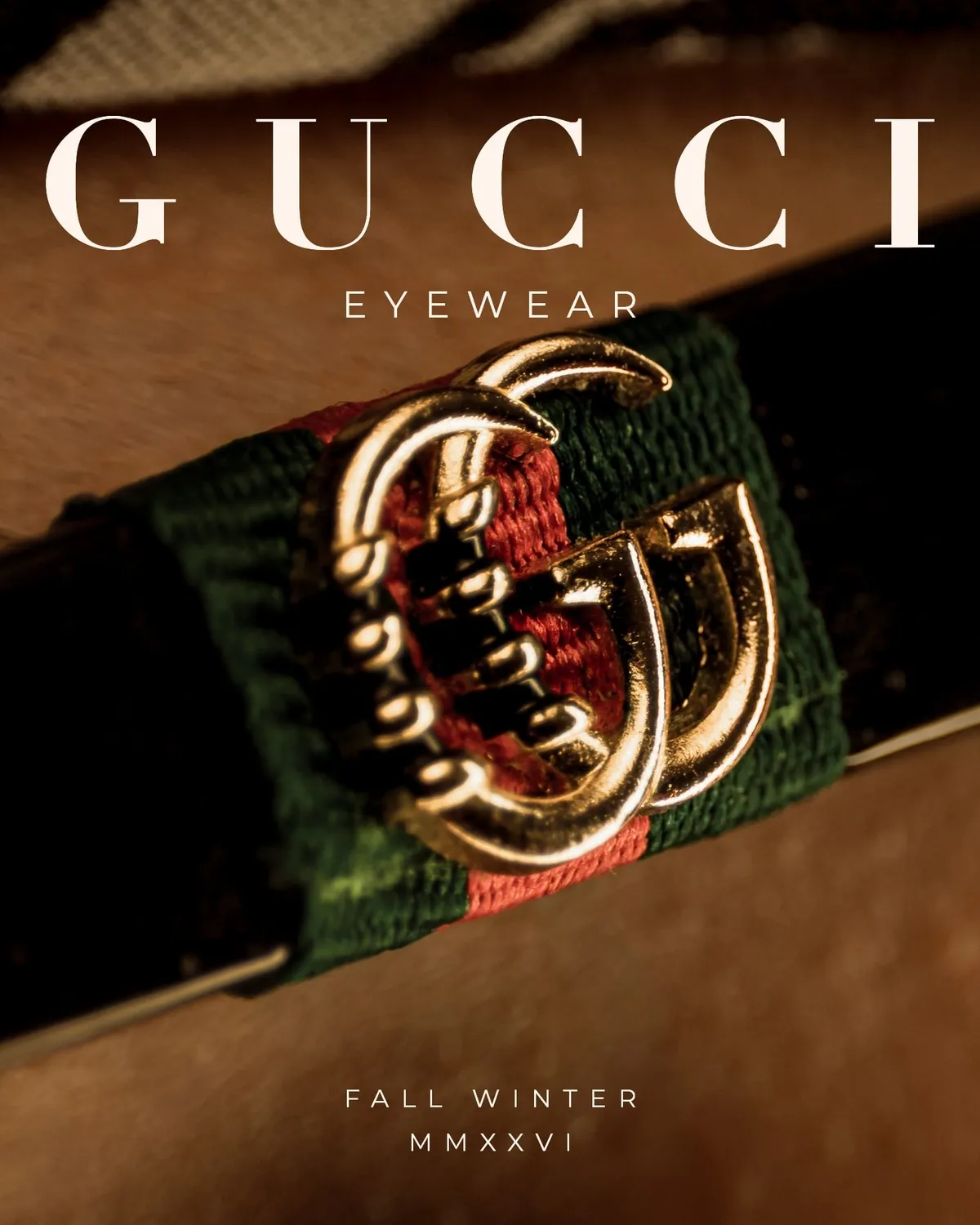Macro of a gold double G emblem on a green and red web stripe, styled as a fall winter eyewear cover · Luxury eyewear, Fall Winter