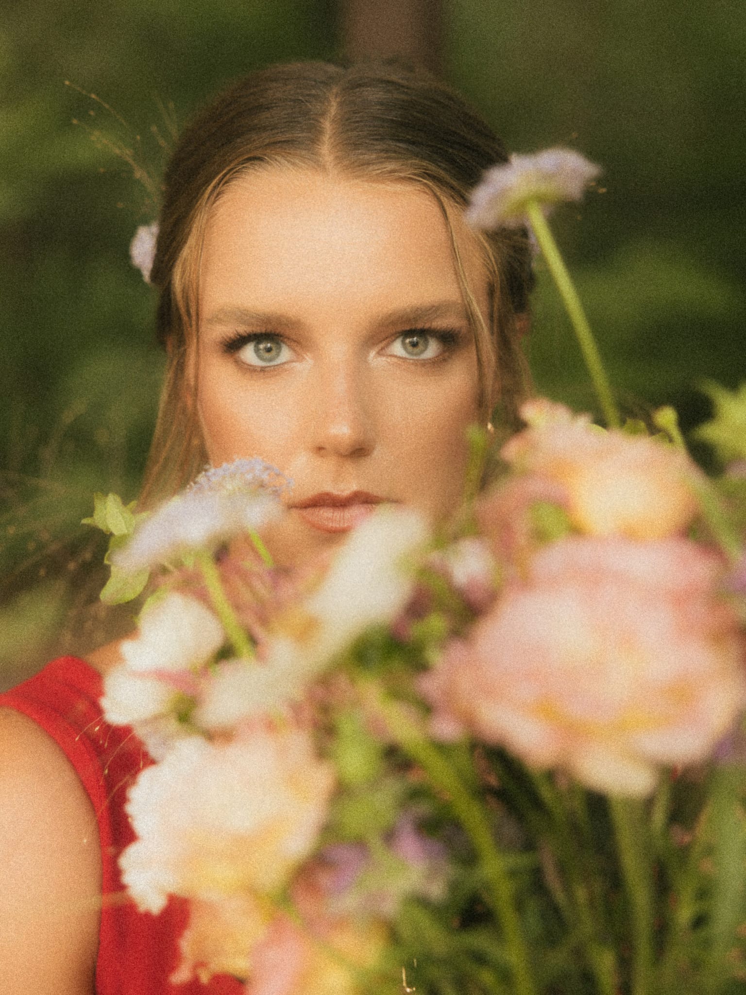 Direct stare over a blurred garden bouquet
