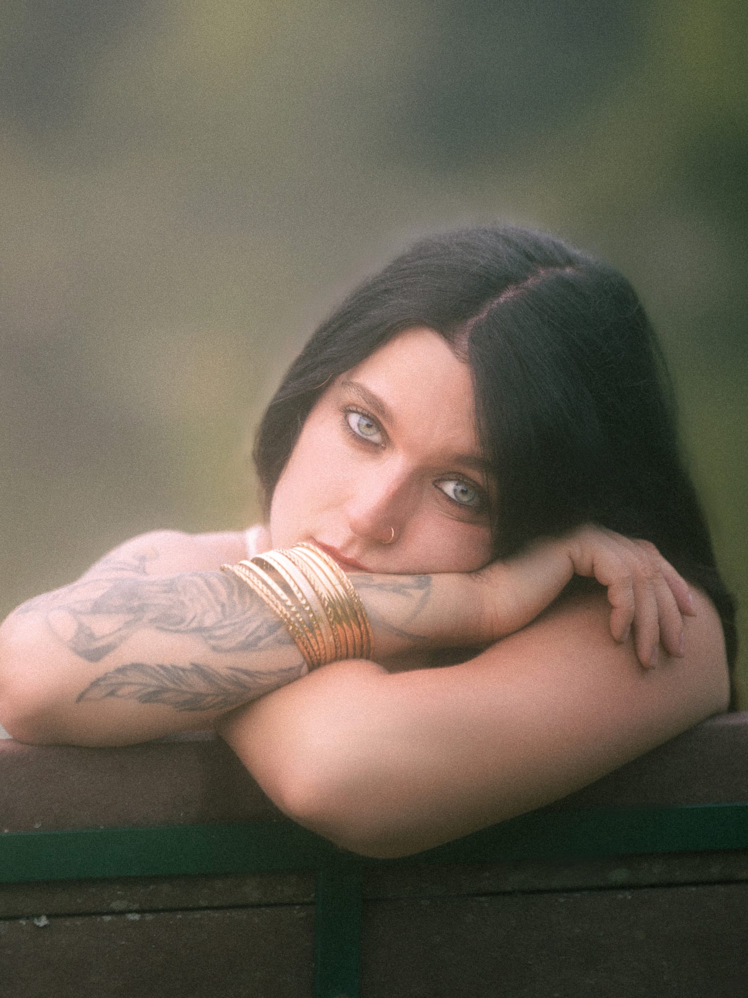 Chin on crossed arms, piercing stare
